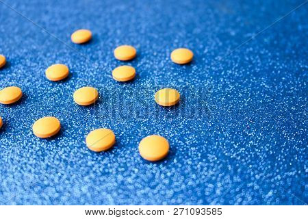 Small Yellow Orange Beautiful Medical Pharmaceptic Round Pills, Vitamins, Drugs, Antibiotics On A Bl