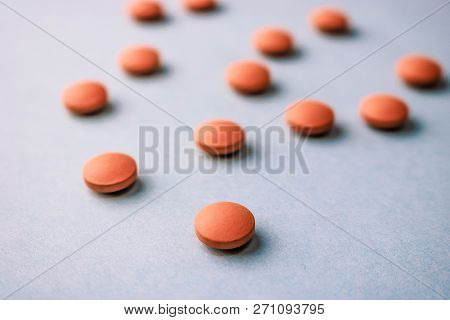 Small Yellow Orange Beautiful Medical Pharmaceptic Round Pills, Vitamins, Drugs, Antibiotics On A Bl