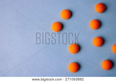 Small Yellow Orange Beautiful Medical Pharmaceptic Round Pills, Vitamins, Drugs, Antibiotics On A Bl