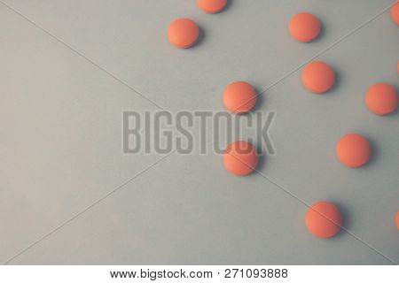 Small Yellow Orange Beautiful Medical Pharmaceptic Round Pills, Vitamins, Drugs, Antibiotics On A Bl