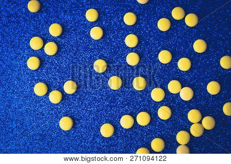 Small Yellow Orange Beautiful Medical Pharmaceptic Round Pills, Vitamins, Drugs, Antibiotics On A Bl