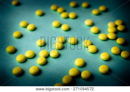 Small Yellow Orange Beautiful Medical Pharmaceptic Round Pills, Vitamins, Drugs, Antibiotics On A Bl