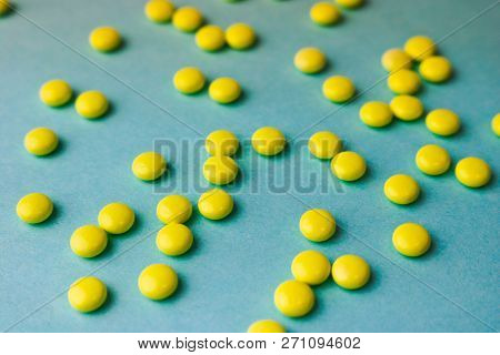 Small Yellow Orange Beautiful Medical Pharmaceptic Round Pills, Vitamins, Drugs, Antibiotics On A Bl