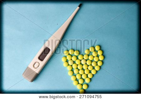 Small Medical Pharmaceptic Round Pills, Vitamins, Drugs In The Form Of A Heart And Electronic Thermo
