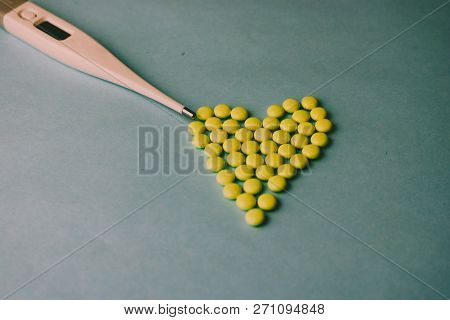 Small Medical Pharmaceptic Round Pills, Vitamins, Drugs In The Form Of A Heart And Electronic Thermo