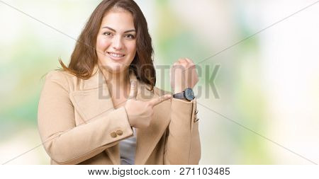 Beautiful plus size young woman wearing winter coat over isolated background In hurry pointing to watch time, impatience, upset and angry for deadline delay
