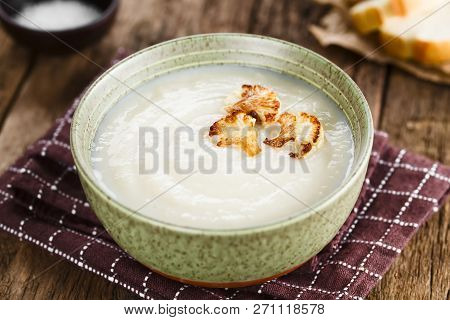 Fresh Homemade Cream Of Cauliflower Soup Garnished With Roasted Cauliflower Floret Slices (selective