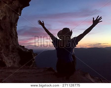 Female Adventurer Admiring Beautiful Sunsets From Mountain Caves