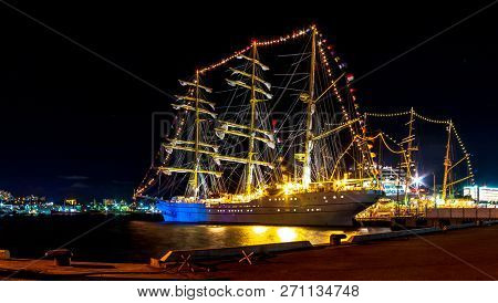 Indonesian Sailboat Kri Bima Suki Moored At Night On A Jetty In The Downtown Of The Far Eastern City