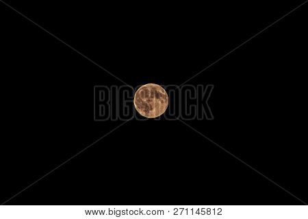 Super Full Moon With Yellow Gold Color On A Black Background