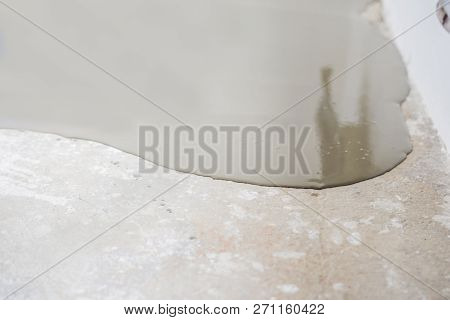 Plasterer During Floor Covering Works With Self-levelling Cement Mortar
