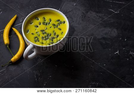 Pumpkin Asian Coconat Cream Soup. Autumn Hot Food. Chili Pepper, Garlic, Red Onion, Big Pumpkin. Dar