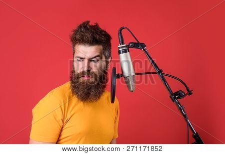 Brutal Bearded Guy Singer With Microphone On Stage. Male Lead Vocalist Singing In Recording Studio. 
