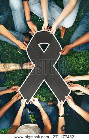 Group of people holding a gray colored ribbon