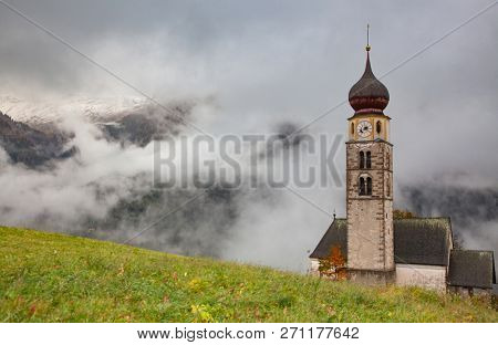 san Valentino church on a foggy late autumn day, Siusi allo Sciliar, Castelrotto, Dolomites, Italy