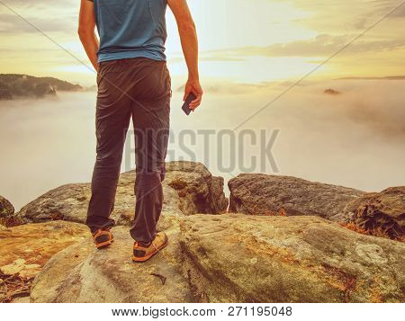 Hiker Takes Selfie Photo, Fall Nature Adventure. Man Sit On Stone On Mountain Sumit  Daybreak Horizo