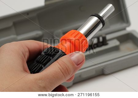 Master Holds In His Hands A Screwdriver. Screwdriver Set In Box On White Background.
