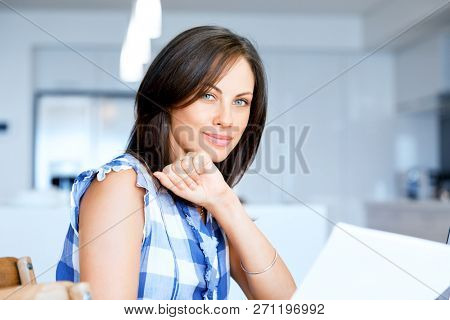 Woman with papers in their living room