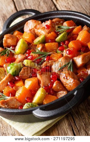 Chicken Stew With Sweet Potatoes, Brussels Sprouts In Pomegranate Sauce Close-up In A Pan On The Tab