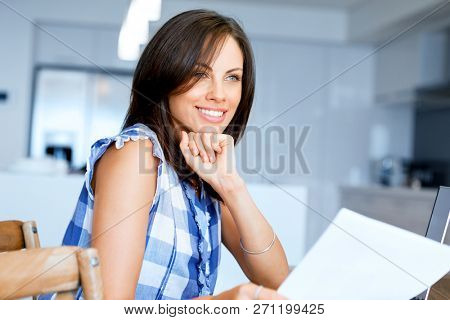 Woman with papers in their living room