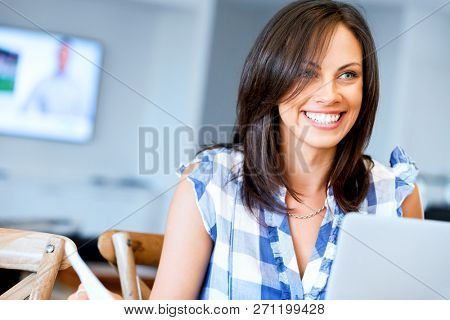 Woman with papers in their living room