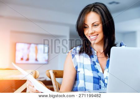 Woman with papers in their living room