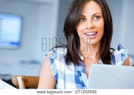 Woman with papers in their living room