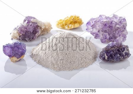 A Pile Of Processed Fluorine Powder Spar Surrounded By Mineral Fluorite Stones Isolated On White.