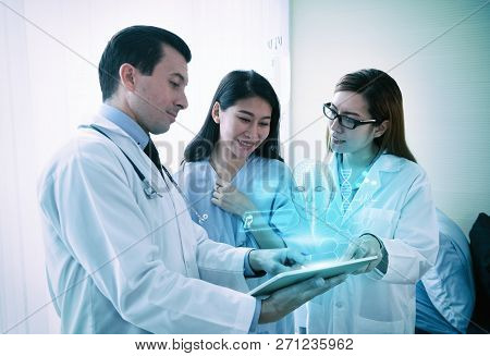 Teams Of Doctors Examining With 3d Vistual Face About Facial Lift Surgery Program To The Patient  At