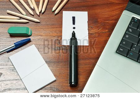 Exclamation Mark Over A Black Pen On Writing Desk