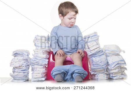 Sad Baby Boy Sitting On Chamber Pot Because He Must Stop Using Diapers. Potty Training Concept