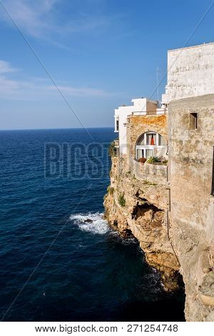 Traditional Houses On Dramatic Cliffs With Caves Rising From Adriatic Sea In Polignano A Mare, Italy