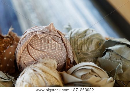 Closeup Of Basket Full Of A Blue, White And Brown Ball Of Matte Crumble