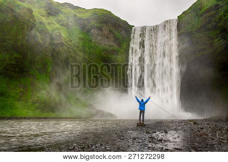 Single Man Standing Near Scogafoss Waterfall In Iceland And Spread His Hands. Travel Summer Nordic C