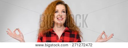 Young Red-haired Girl In A Red Checkered Shirt. Young Girl Meditates
