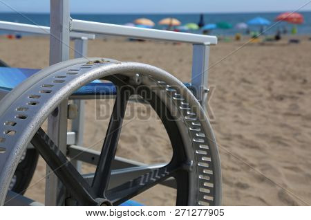 Detail Of A Wheelchair With Modified Wheels To Be Able To Go On The Beach Sand
