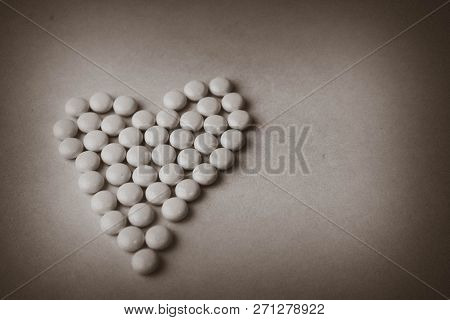 Small Medical Pharmaceptic Round Pills, Vitamins, Drugs, Antibiotics In The Form Of A Heart On A Bla