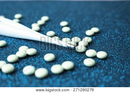 Small Medical Pharmacetic Round Tablets, Vitamins, Drugs And Electronic Digital Thermometer On A Blu