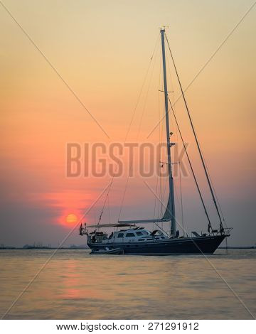 A Boat With A Colorful Sunset Sky At Mutiara Beach