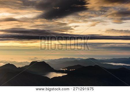 Mountain Silhouettes With Dramatic Morning Sky On Peak Of Kerinci