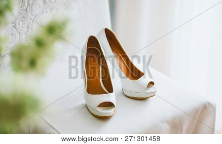 Wedding Shoes Stand On A White Chair
