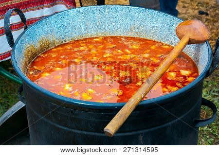 Hecha, Ukraine - Jan 27, 2018: Pork Butchers Competition. Wooden Spoon On Top Of Huge Pot Full Of Bo