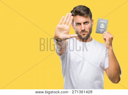 Young handsome man holding passport of united states over isolated background with open hand doing stop sign with serious and confident expression, defense gesture
