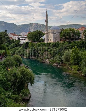 Koski Mehmed Pasha Mosque On The Banks Of The Neretva River In Mostar, Bosnia And Herzegovina On A S