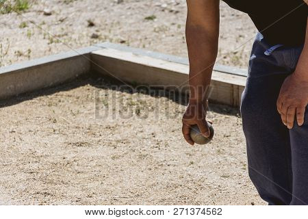 Senior People Prepared To Throw The Boules Ball In A Park In Outdoor Play