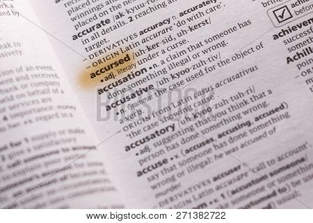 The Word Or Phrase Accursed In A Dictionary Highlighted With Marker.