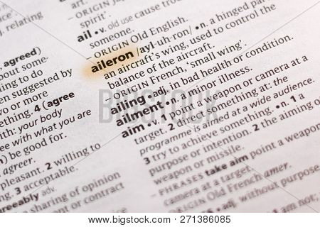 The Word Or Phrase Aileron In A Dictionary Highlighted With Marker.