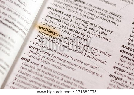 The Word Or Phrase Ancillary In A Dictionary Highlighted With Marker.