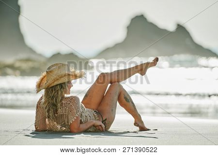 young woman relaxing on the beach in summer day