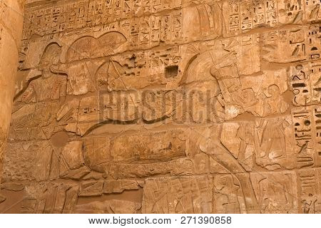 Egyptian Hieroglyphs And Drawings On The Walls And Columns. Egyptian Language, The Life Of Ancient G